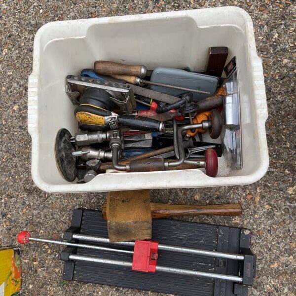 Vintage carpenter's tool lot in a crate, including hand tools.
