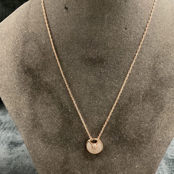 Rose gold Cartier style Amulette necklace on a mannequin.