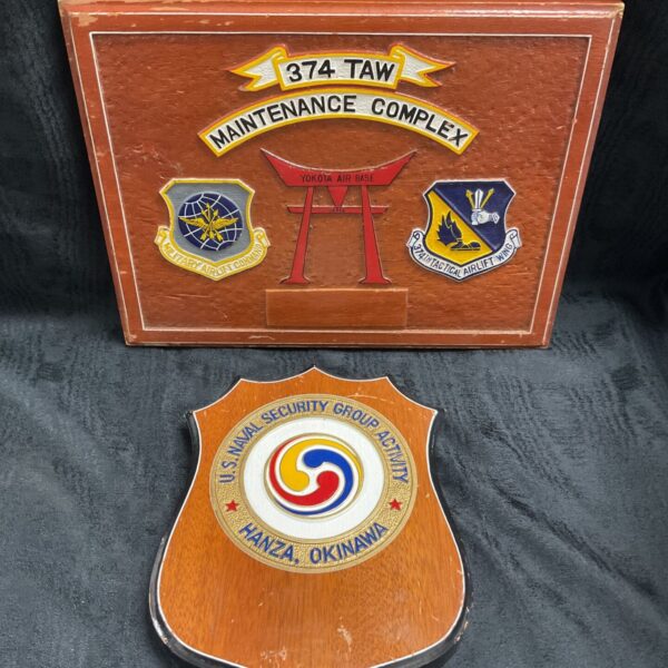 Carved 374 TAW Maintenance Complex wooden plaque beside Hanza Okinawa shield plaque