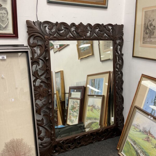 Large antique carved oak wall mirror with pierced foliate frame and bevelled glass