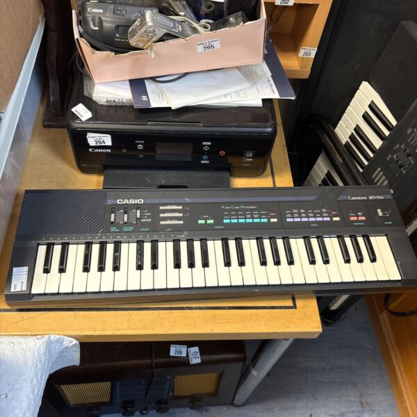 Vintage Casio Casiotone MT-110 keyboard with keys and controls visible.