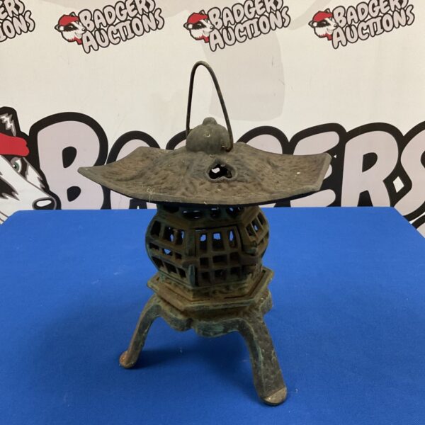 Cast iron pagoda candle lantern with green patina and pierced lattice body