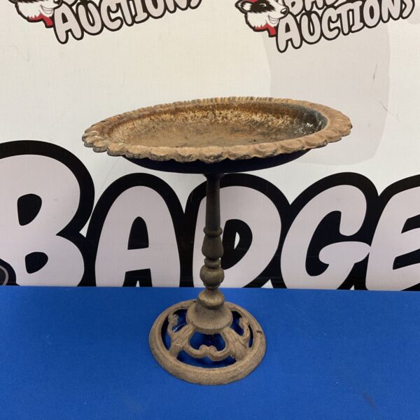 Small rustic cast-iron pedestal bird bath with scalloped rim and pierced base