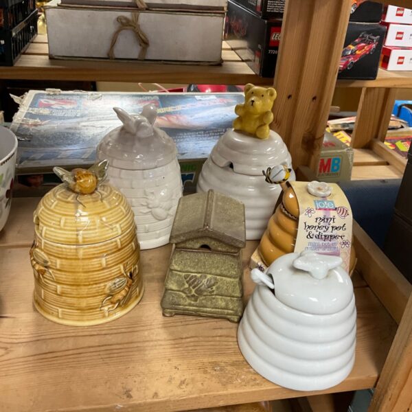 Vintage ceramic honey pot shaped like a beehive.