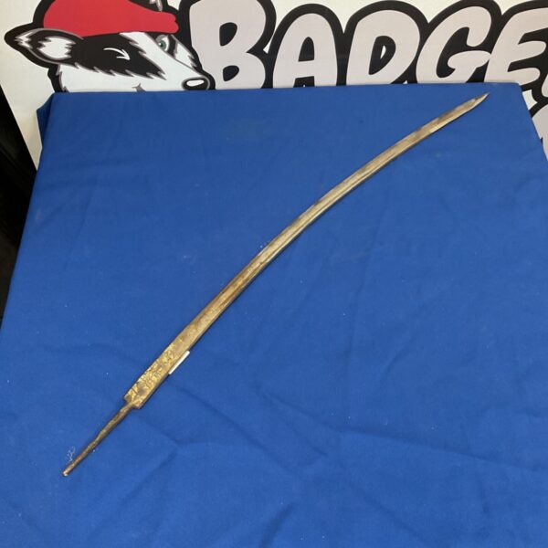 Antique ceremonial sword blade with etched details.