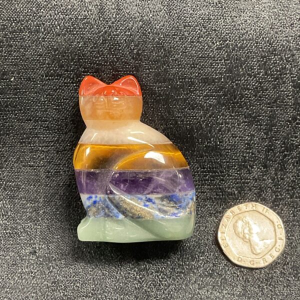 Colourful chakra cat figurine carved from gemstones.