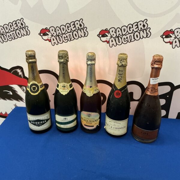 Mixed lot of champagne and alcohol bottles for auction.