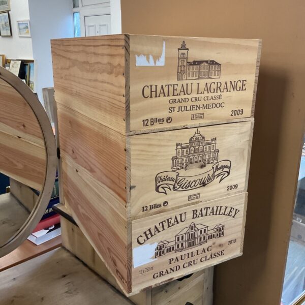 Three stacked wooden wine crates from Chateau Lagrange, Giscours and Batailley