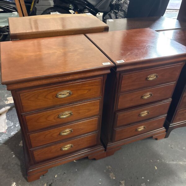 Pair of cherry wood four drawer bedside chests with brass oval handles