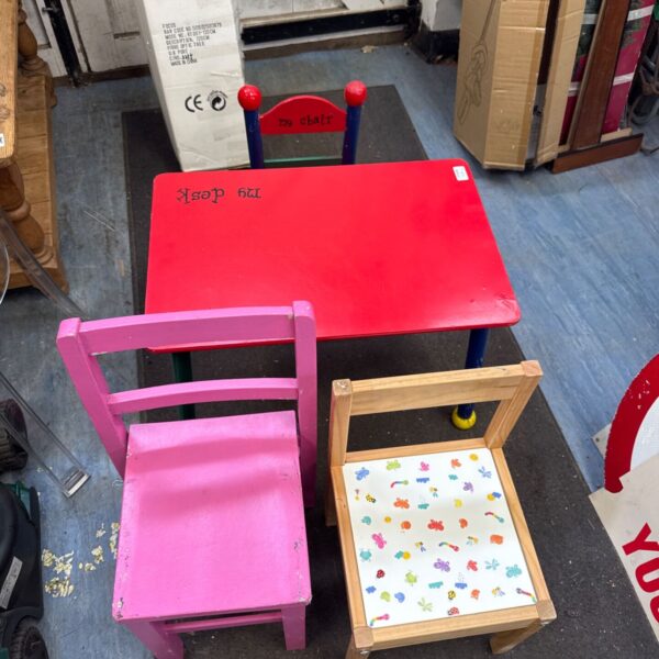 Colourful vintage children’s desk and chair set in pink and red.