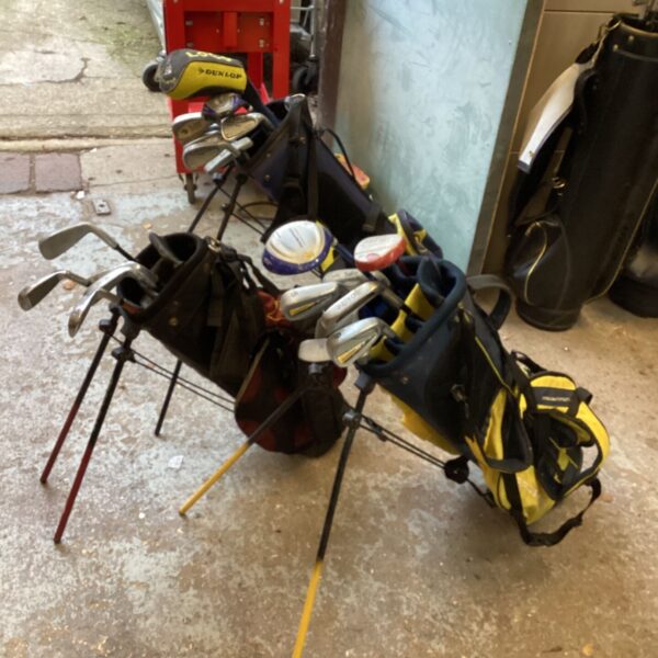 Three children's golf club sets with stand bags and Dunlop headcover