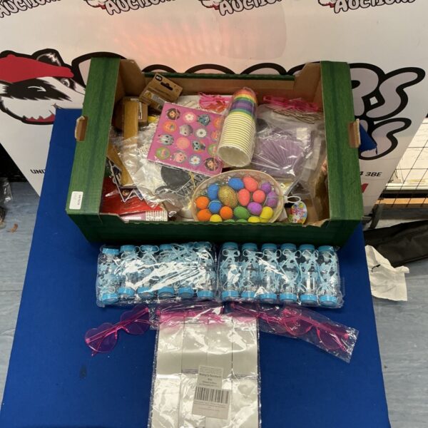 Box of colourful children’s party supplies and decorations.