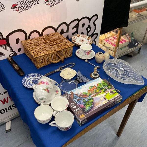 Mixed lot of vintage china tea cups and saucers on display.