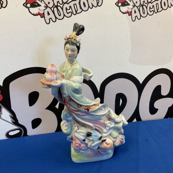 Hand-painted Chinese porcelain figurine of a celestial maiden.