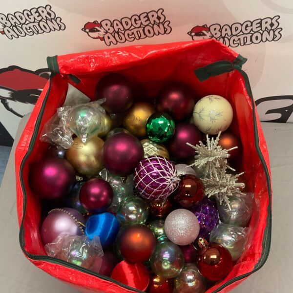 Large collection of colourful Christmas baubles in a red bag.