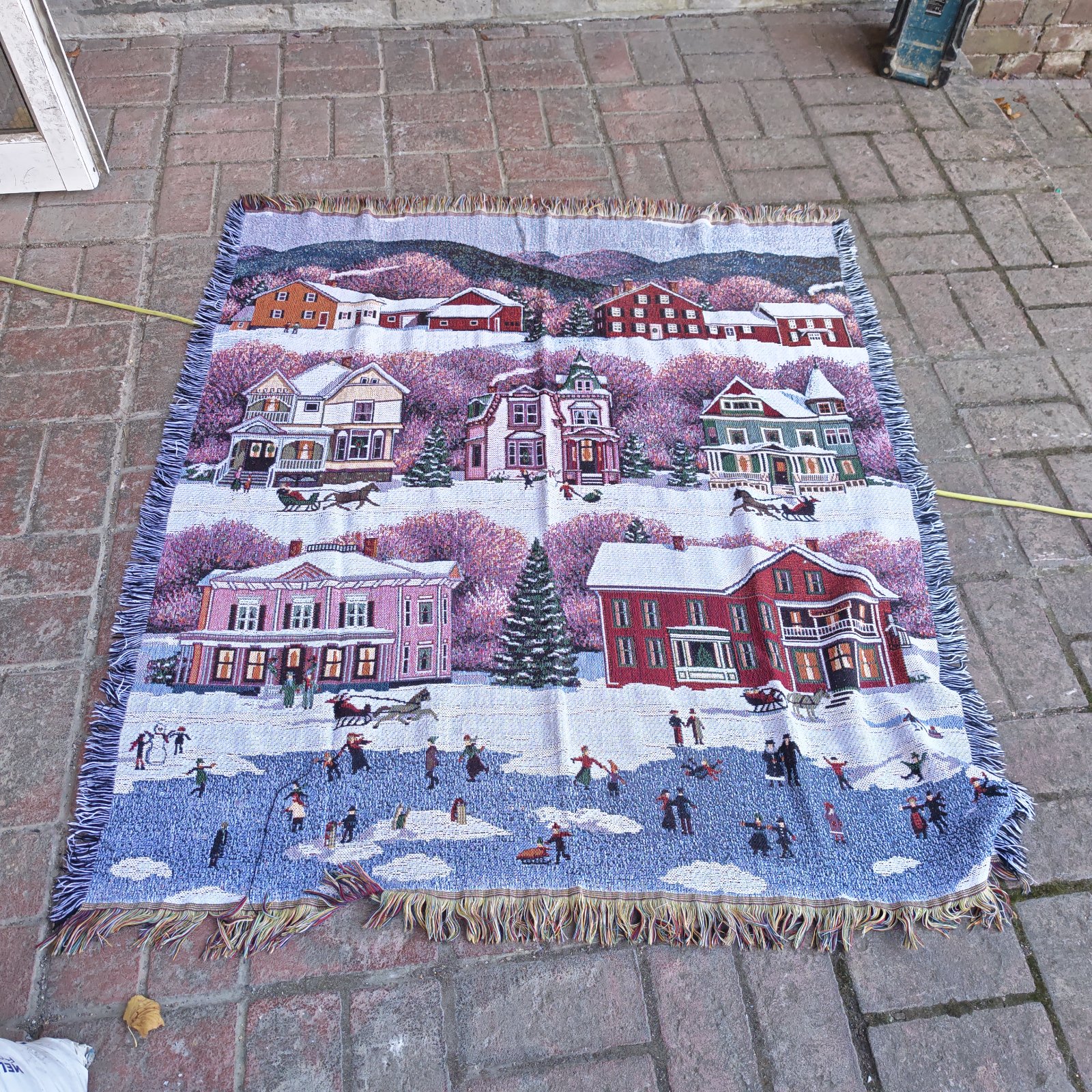 Detailed Christmas lake blanket with winter scene and figures skating.