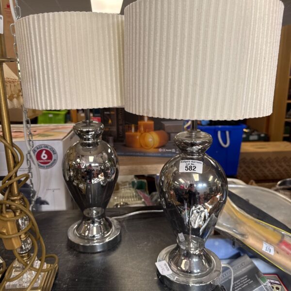 Pair of vintage chrome table lamps with frosted glass shades.