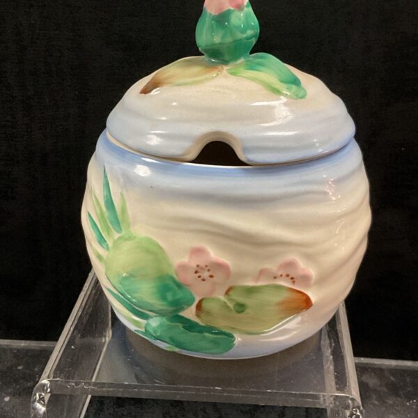 Clarice Cliff Water Lily preserve pot with bud finial, front view.