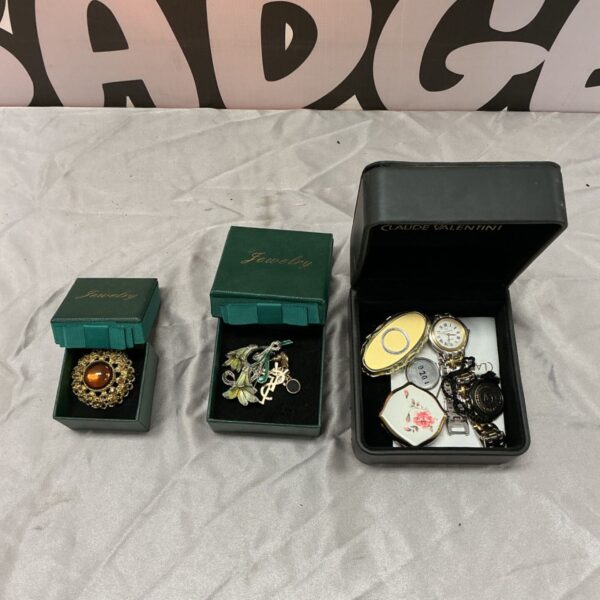 Claude Valentini wristwatch, brooches and pill boxes in green and black presentation boxes