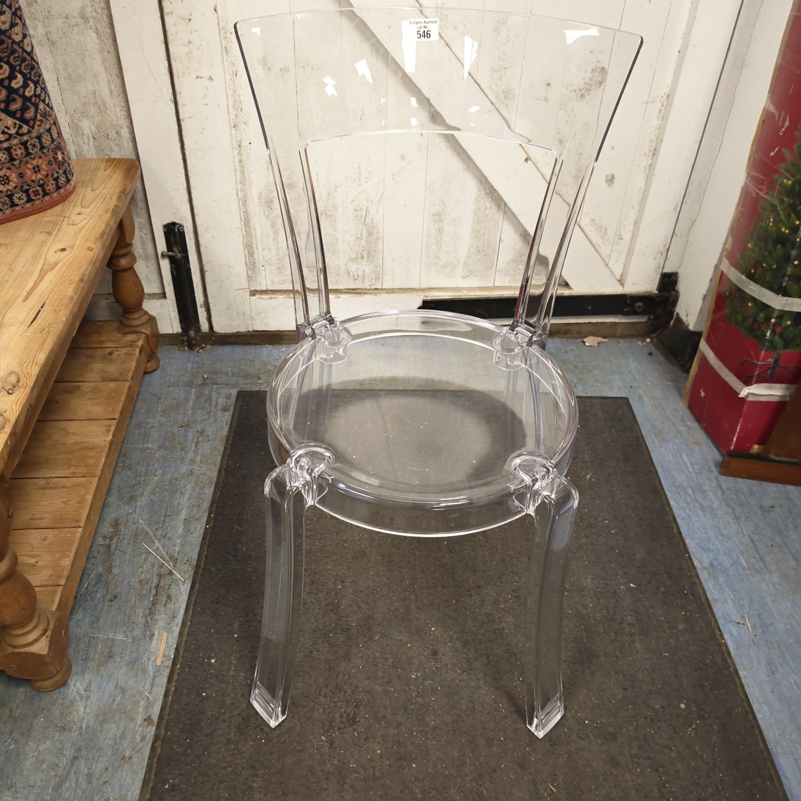Clear perspex designer chair with a modern sculpted form.