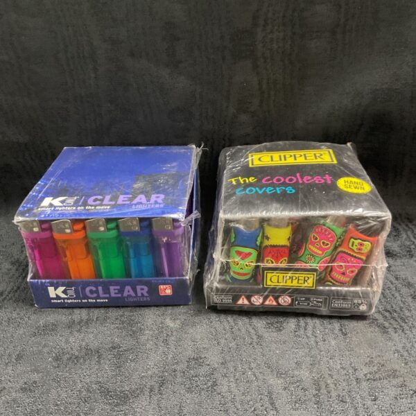 Two sealed packs of Clipper hand sewn covers and Ktwo clear gas lighters