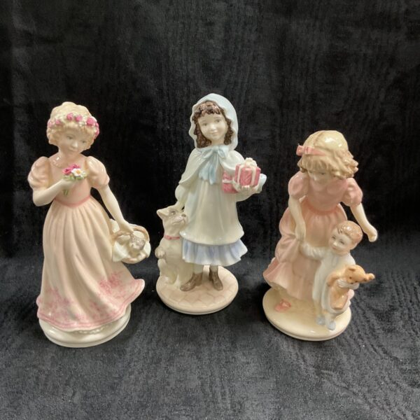 Group of three Coalport limited edition porcelain figures.