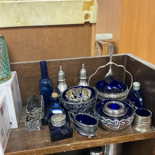 Cobalt blue glass collection with silver rims on display.
