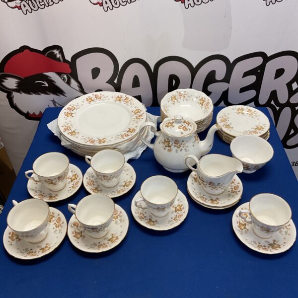 Colclough Autumn Leaf tea set with dinner plates, teapot and cups on blue cloth