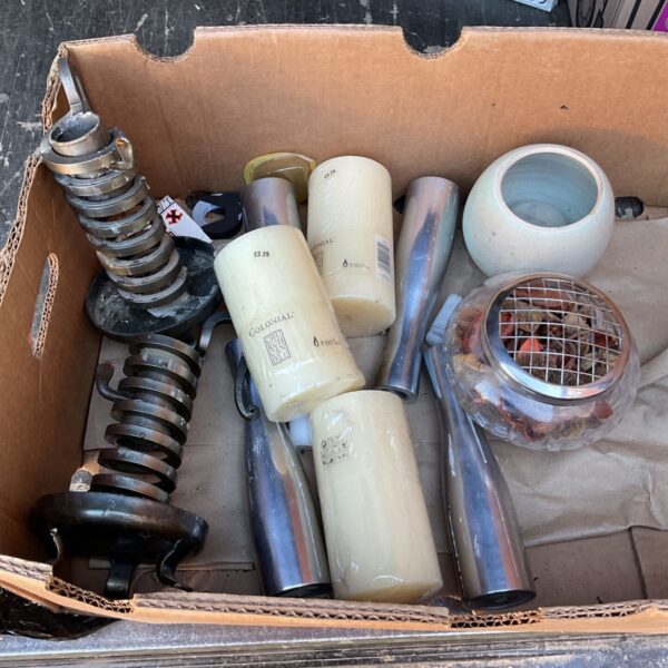 Tray of vintage colonial candles and candlesticks for home decor.