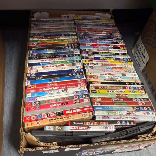 Stack of comedy and kids DVDs for family entertainment.
