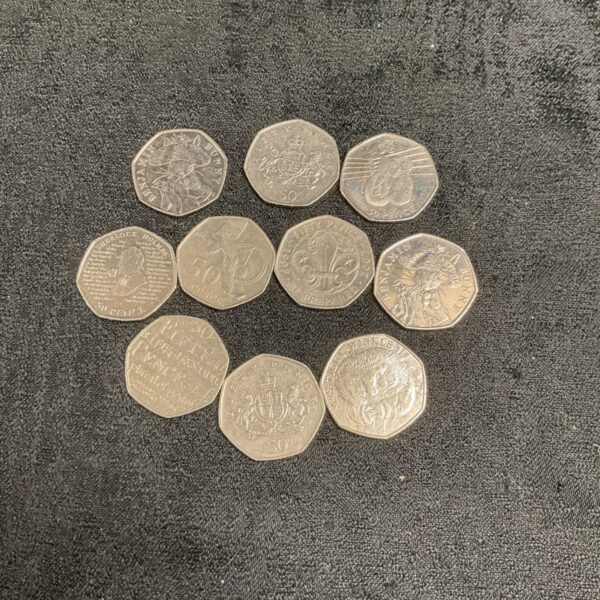Collection of ten commemorative 50p coins including Sherlock Holmes.