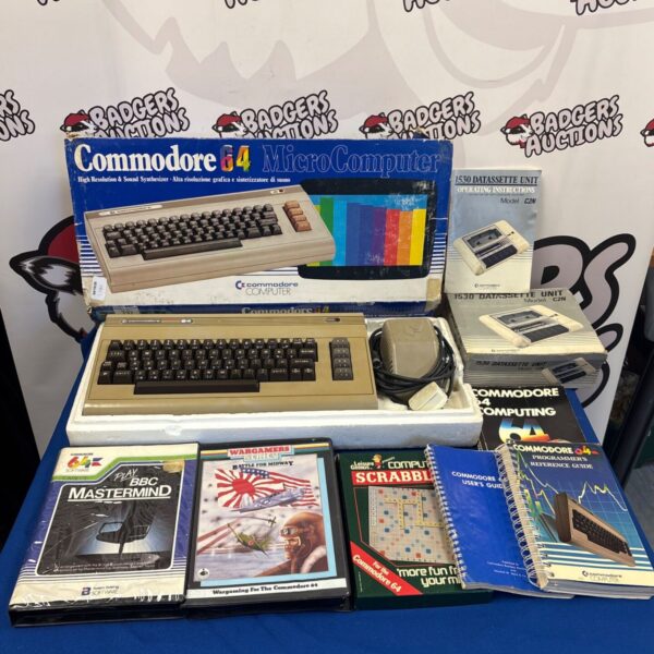 Boxed Commodore 64 computer with 1530 datasette unit and accessories.