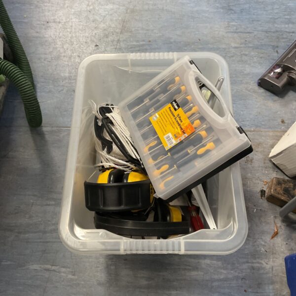 Clear storage box of construction equipment with Rolson screwdriver set and Peltor earmuffs