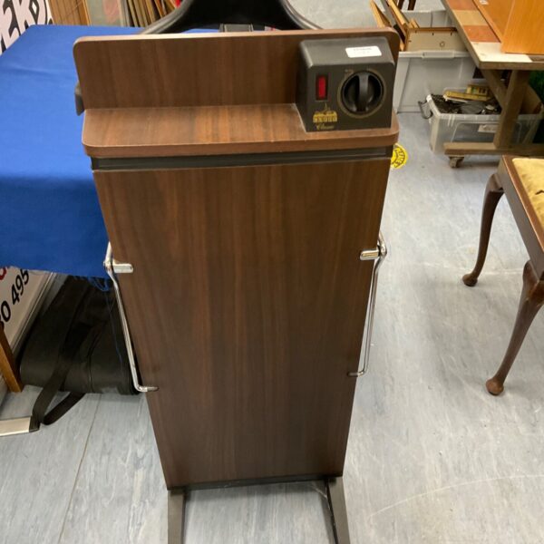 Vintage Corby trouser press in a home setting.