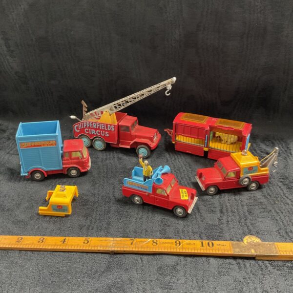 Five vintage Corgi Chipperfields Circus diecast vehicles displayed together on dark surface