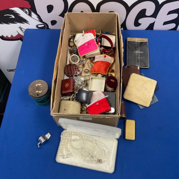 Mixed lot of vintage costume jewellery in a cardboard box.