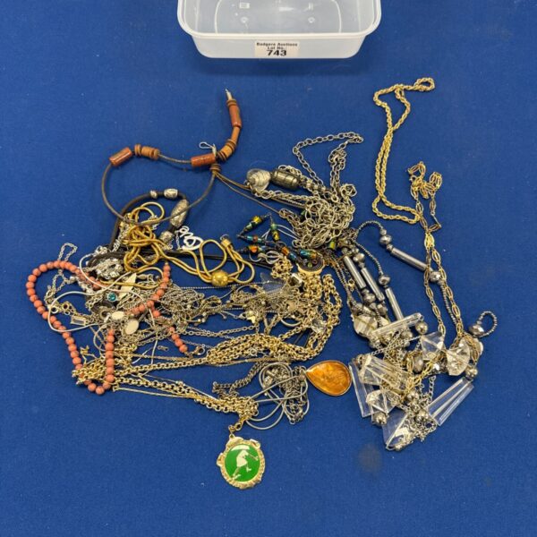 Costume jewellery necklaces lot with lawn bowls medal displayed.
