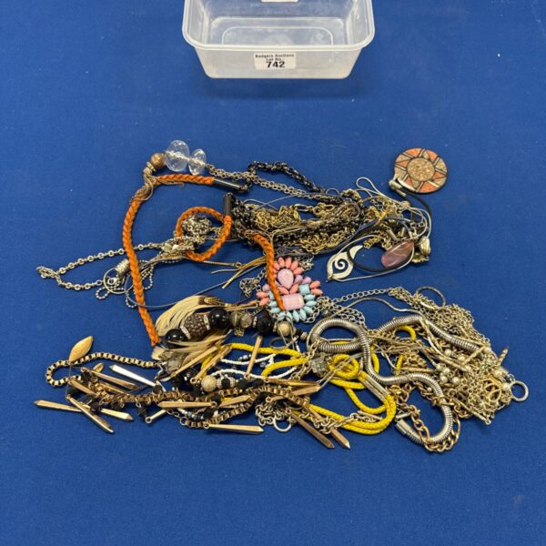 Selection of thirty costume jewellery necklaces in a plastic container.