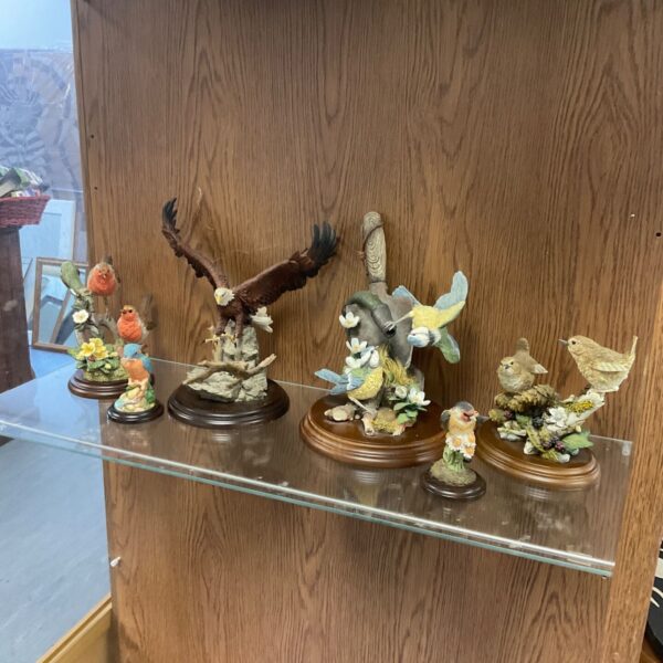 County Arts Collections bird figurines including robins, eagle and wrens on glass shelf