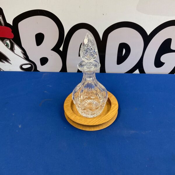 Small crystal decanter with wooden stand, vintage glassware.