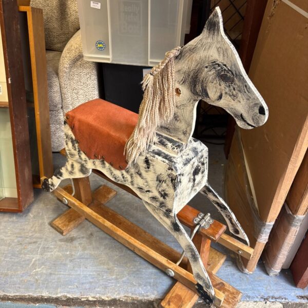 Vintage dapple grey rocking horse, a charming antique toy.
