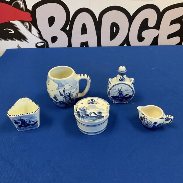 Delft blue pottery collection featuring miniature jugs and a trinket pot.