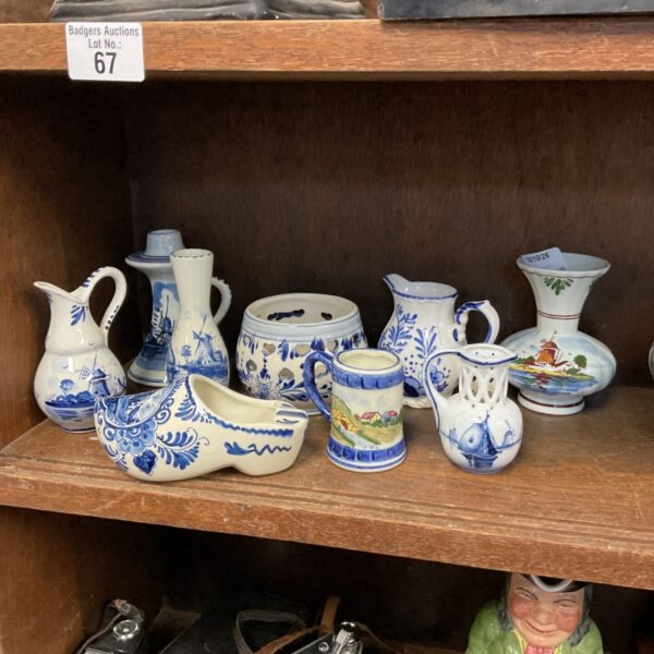 Delft pottery collection featuring blue and white jugs and vases.