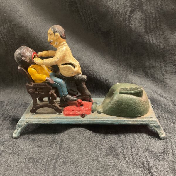 Antique style dentist coin bank, cast iron mechanical bank.