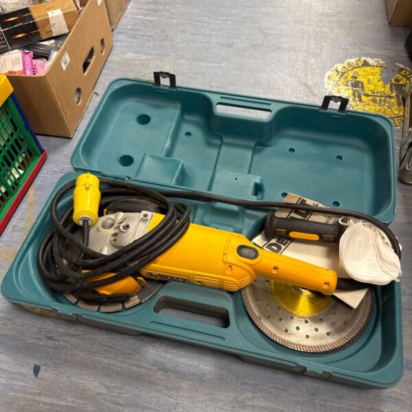 Dewalt disc cutter in green carrying case with accessories.
