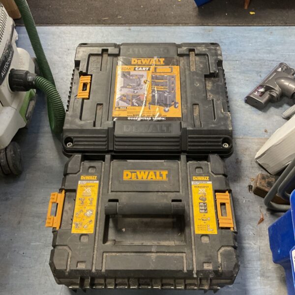 DeWalt TSTAK storage box and yellow TSTAK cart on blue workshop floor