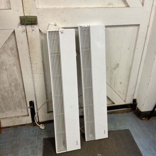 Two white Dimplex wall heaters with timers for home heating.