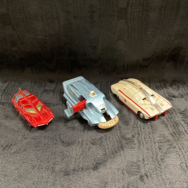Three vintage Dinky Toys Captain Scarlet vehicles displayed on a dark grey background