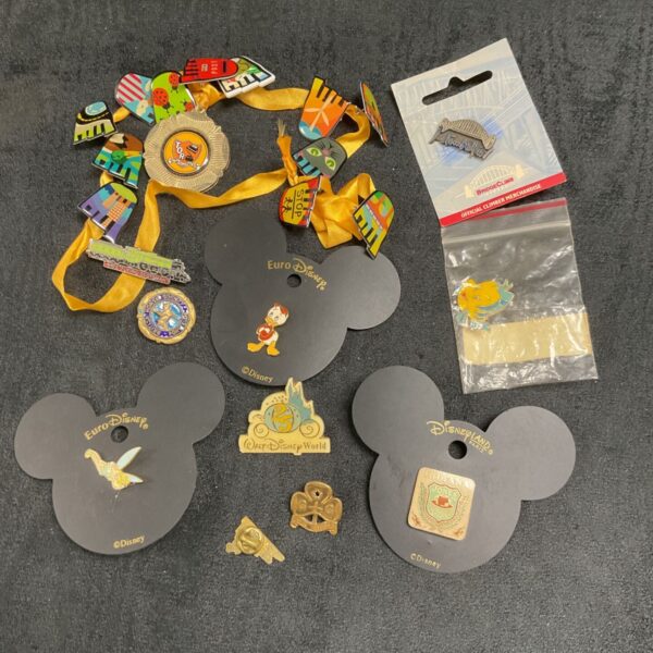 Collection of colourful Disney pin badges for collectors.