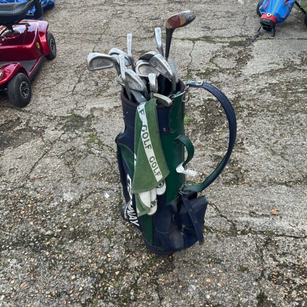 Green and navy Donnay International golf bag holding irons and a wooden-headed club